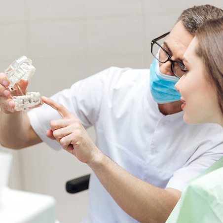 a dentist explaining dental implants to a patient