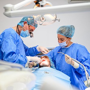 an oral surgeon performing dental implant surgery