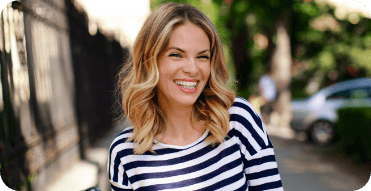 Smiling blonde woman in striped blouse