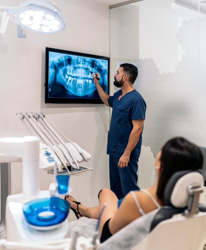 Dentist showing a patient x rays of their teeth