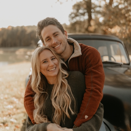 Grenada dentists Doctor Kasey Kringle and Doctor Kyle Kringle hugging outdoors