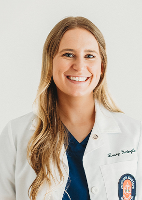 Grenada dentist Doctor Kasey Kringle smiling in white lab coat