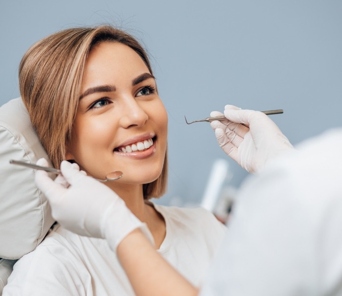 Woman smiling at her dentist during preventive dentistry checkup